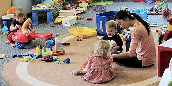 Photo of children in nursery with caregiver