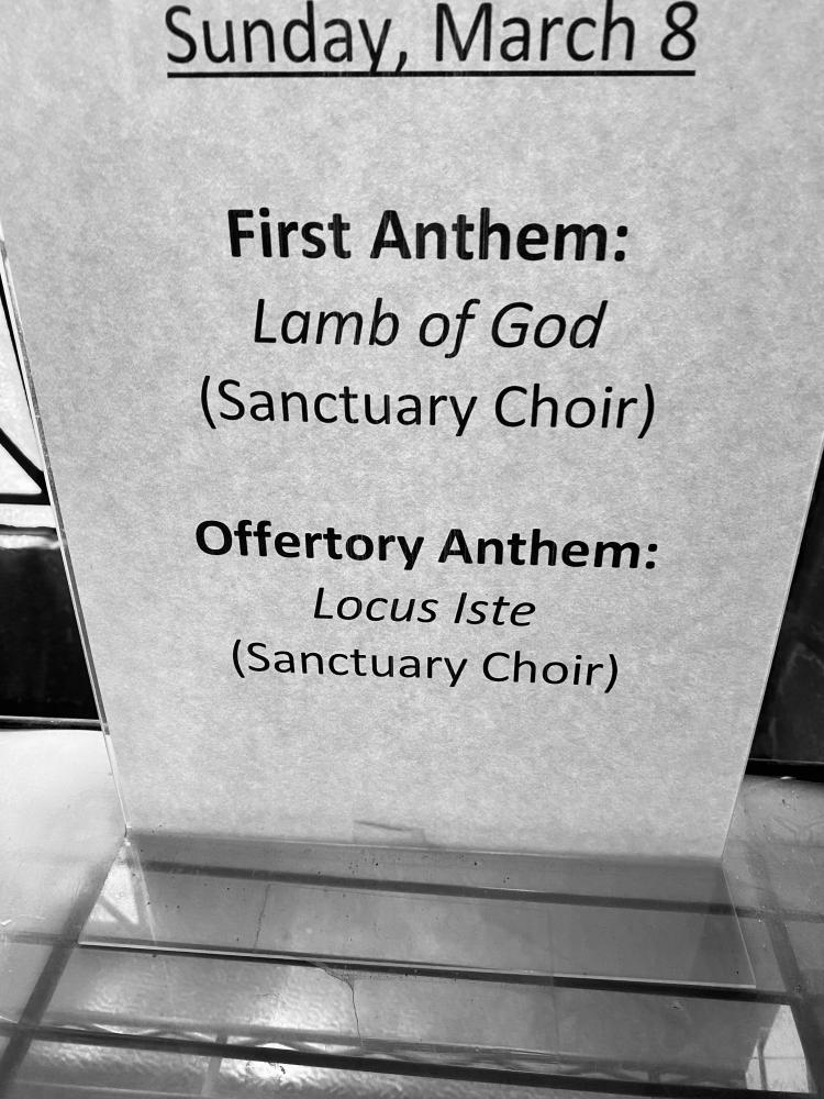 A sign in the choir loft hallway reminding singers what they will sing that morning. We have left this in place as a reminder of where we were a year ago.